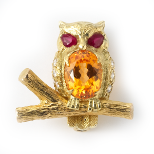 Owl on branch with ruby eyes